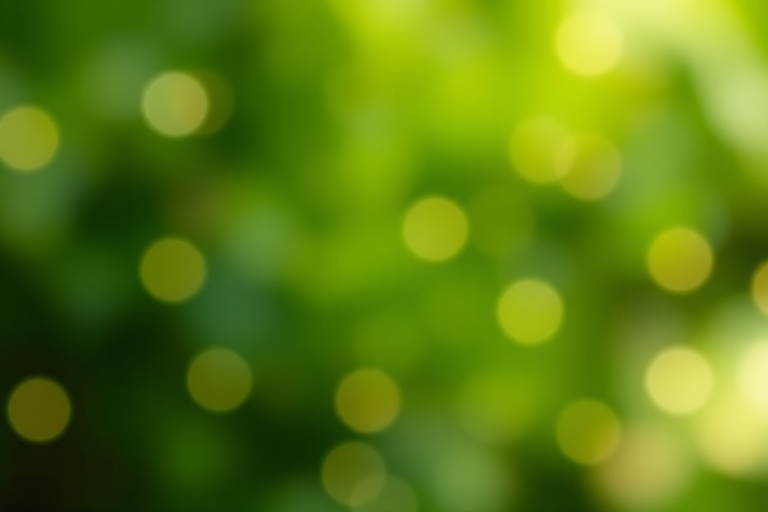 Create a soft-focus abstract background with varying shades of green and scattered glowing dots, using a Canon EOS R5, 50mm lens at f/1.8, ISO 100, 1/160s shutter speed, in a shallow depth of field, with a bokeh effect.