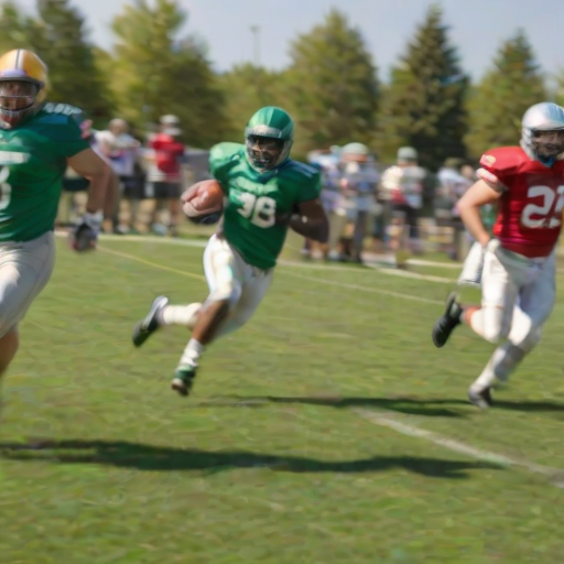 Blurry action shot of a football game in progress, players sprinting across the field with determination, colorful team jerseys contrasting against the green grass under a clear blue sky.