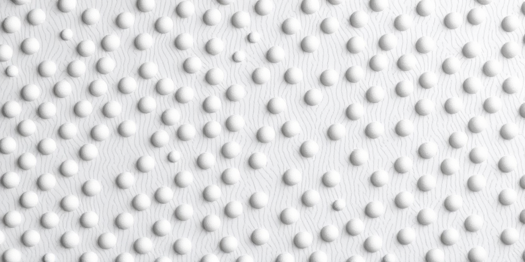 Generate a high-resolution image of a textured background with evenly spaced drop-shaped depressions in a light gray color, using a DSLR camera at f/8 aperture, ISO 200, shutter speed 1/125s, with a top-down view and soft diffused lighting to enhance details.
