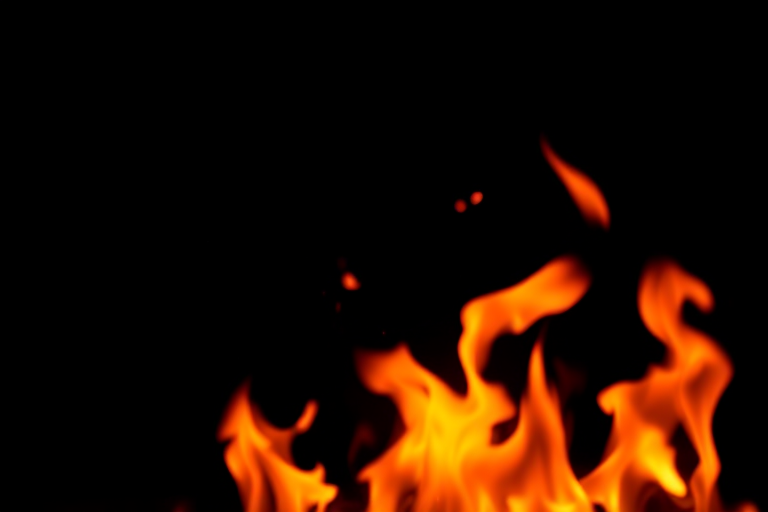 high-resolution image of vibrant flames on a dark background, using a Canon EOS 5D Mark IV, 50mm lens, f/1.8 aperture, ISO 100, 1/200 sec shutter speed, shot in soft focus with a shallow depth of field to enhance the details of the fire.