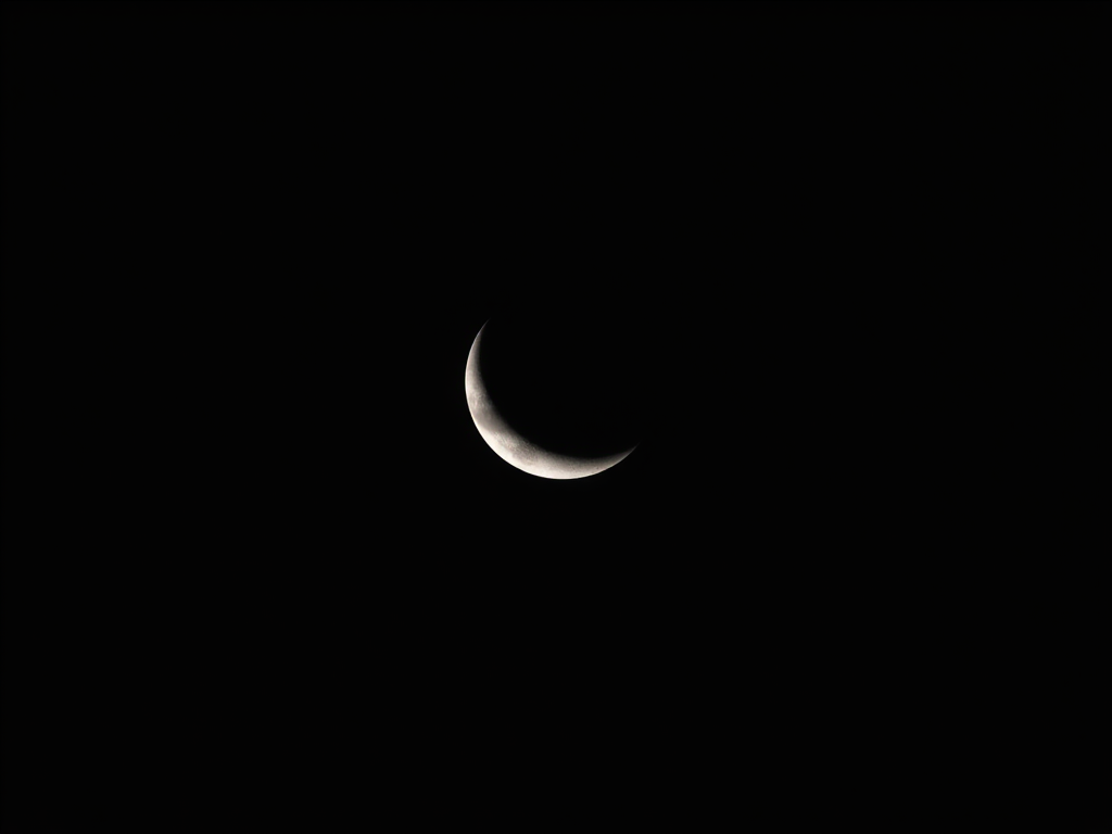 Capture a high-resolution image of a crescent moon against a deep black sky using a DSLR camera with a 300mm lens, ISO 400, aperture f/8, shutter speed 1/200s, in a telephoto view for enhanced detail and clarity.