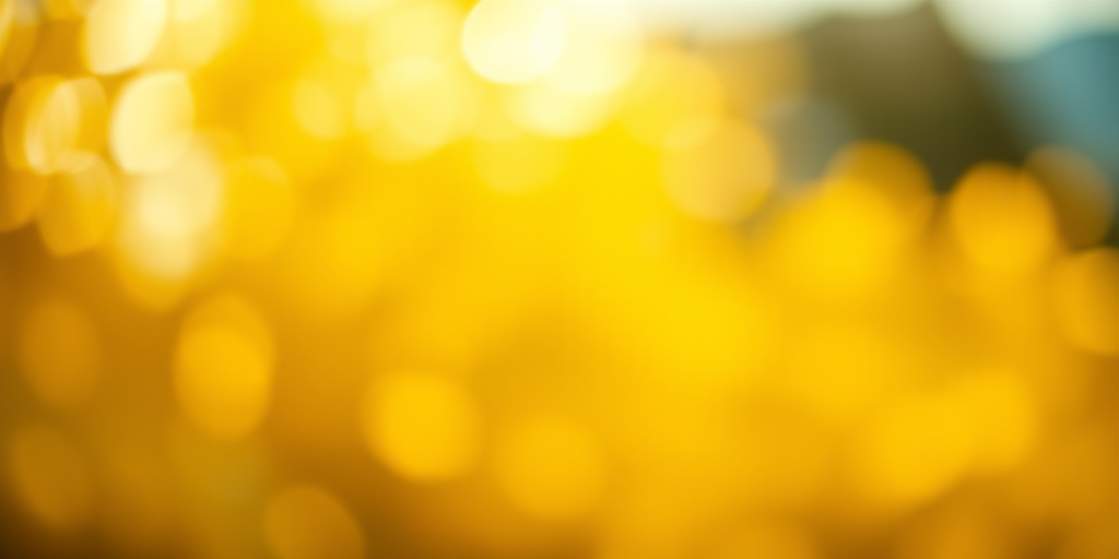 Generate a vibrant abstract image with a soft bokeh effect in various shades of yellow, using a DSLR camera with a 50mm lens at f/1.8, ISO 100, and a shallow depth of field for enhanced quality.