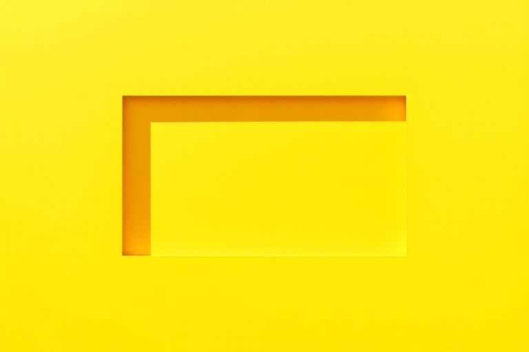 Create a vibrant yellow rectangular shape with a soft shadow effect, shot with a DSLR camera, 50mm lens, f/2.8 aperture, ISO 100, natural lighting for enhanced image quality and clarity.