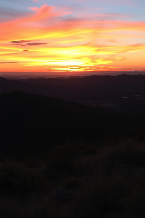 Generate a high-resolution image of a serene landscape at sunset with vibrant colors, using a DSLR camera, 50mm lens, f/1.8 aperture, ISO 100, with a wide-angle view to capture the expansive sky and foreground details.