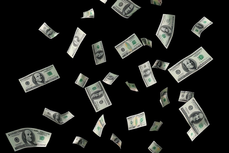 Create an image of banknotes falling gracefully against a black background, captured with a Canon EOS R5, 85mm lens, aperture f/1.4, shutter speed 1/200s, ISO 100, using a softbox lighting setup to enhance shadows and highlights for a dynamic and vibrant effect.