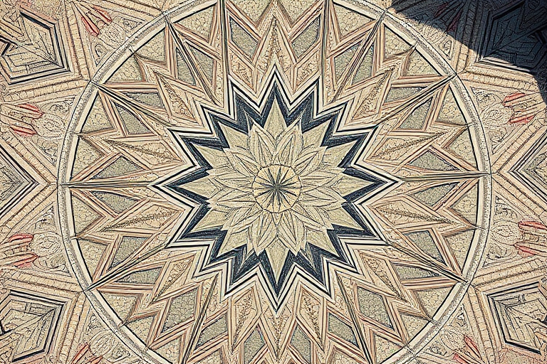 Create a high-resolution image of a stylized geometric design featuring a central star shape with intricate patterns radiating outward, captured with a Canon EOS 5D Mark IV at f/8 aperture, ISO 100, 1/125 sec exposure, with a wide-angle lens from a top-down view, using natural lighting.