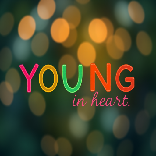 Create an image featuring the text "YOUNG at heart" in a vibrant, colorful design, using a DSLR camera with a 50mm lens, aperture f/1.8, shutter speed 1/125s, ISO 200, in a soft-focus background with bokeh effects and a high dynamic range.