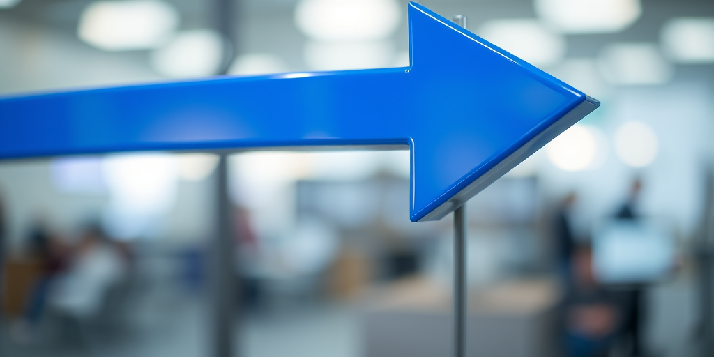 create an image of a large, glossy blue arrow pointing to the right, using a DSLR camera with a 50mm lens, aperture f/2.8, ISO 100, and a shallow depth of field to emphasize the arrow against a blurred background