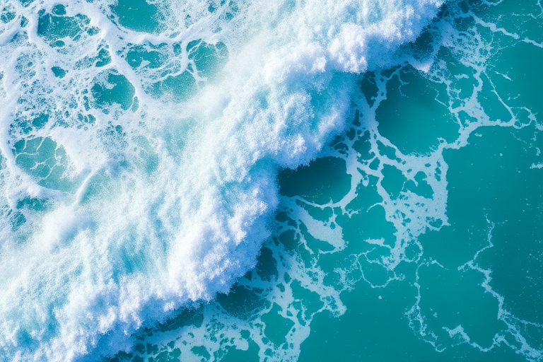 high-angle shot of crashing ocean waves with vibrant turquoise and white foam, captured with a DSLR camera using a 50mm lens, aperture f/8, shutter speed 1/500s, ISO 200, natural light for sharp details and vivid colors.