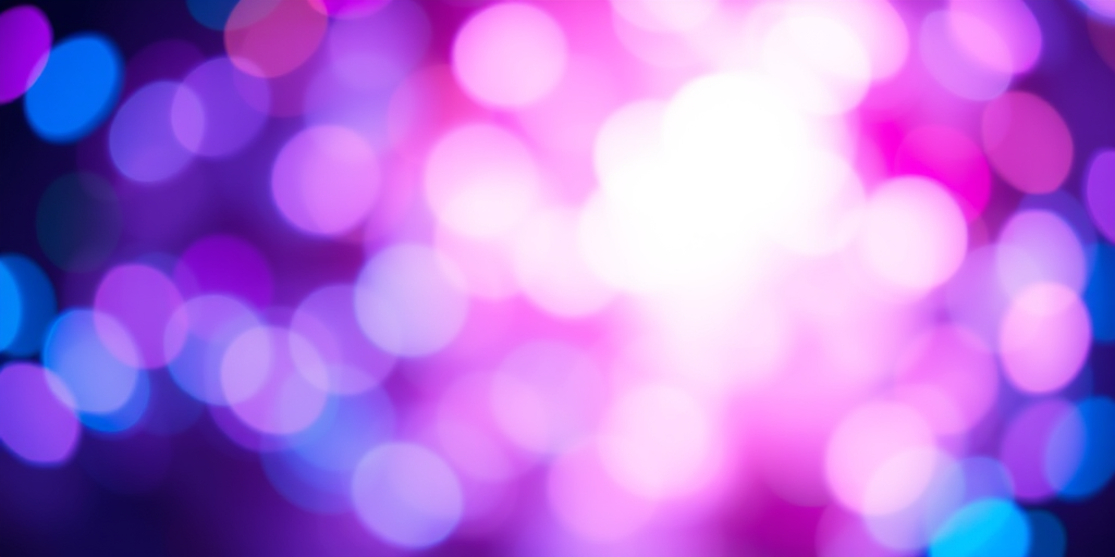 Create an abstract image of swirling multicolored bokeh lights in vibrant hues of blue, purple, and pink, using a Canon EOS R camera with a 50mm lens, aperture set to f/1.8, ISO 100, shutter speed 1/60s, capturing a shallow depth of field with a soft focus background and a high dynamic range for enhanced brightness and contrast.