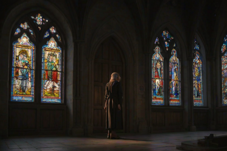 Old European church at twilight, stained glass windows glowing softly, a woman stands in the doorway, her hands clasped in quiet reverence as she takes in the sacred atmosphere.