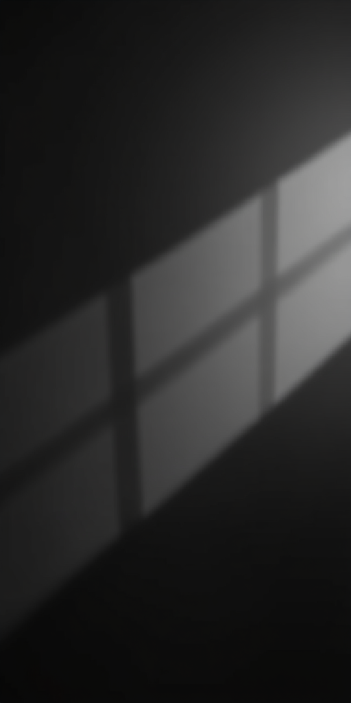 create an abstract low-poly background with a gradient from dark gray to black, capturing subtle light reflections and shadows using a Canon EOS R5, 50mm lens, f/1.8 aperture, ISO 100, in a soft natural light setting