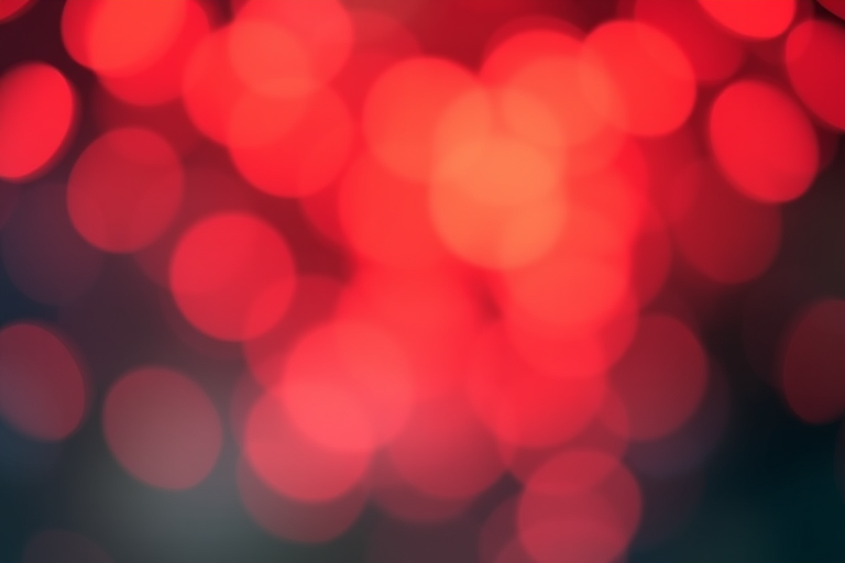 create a soft bokeh background with warm red and orange circular light spots, using a Canon EOS 5D Mark IV, ISO 100, f/1.8, 50mm lens, and a shallow depth of field for enhanced image quality