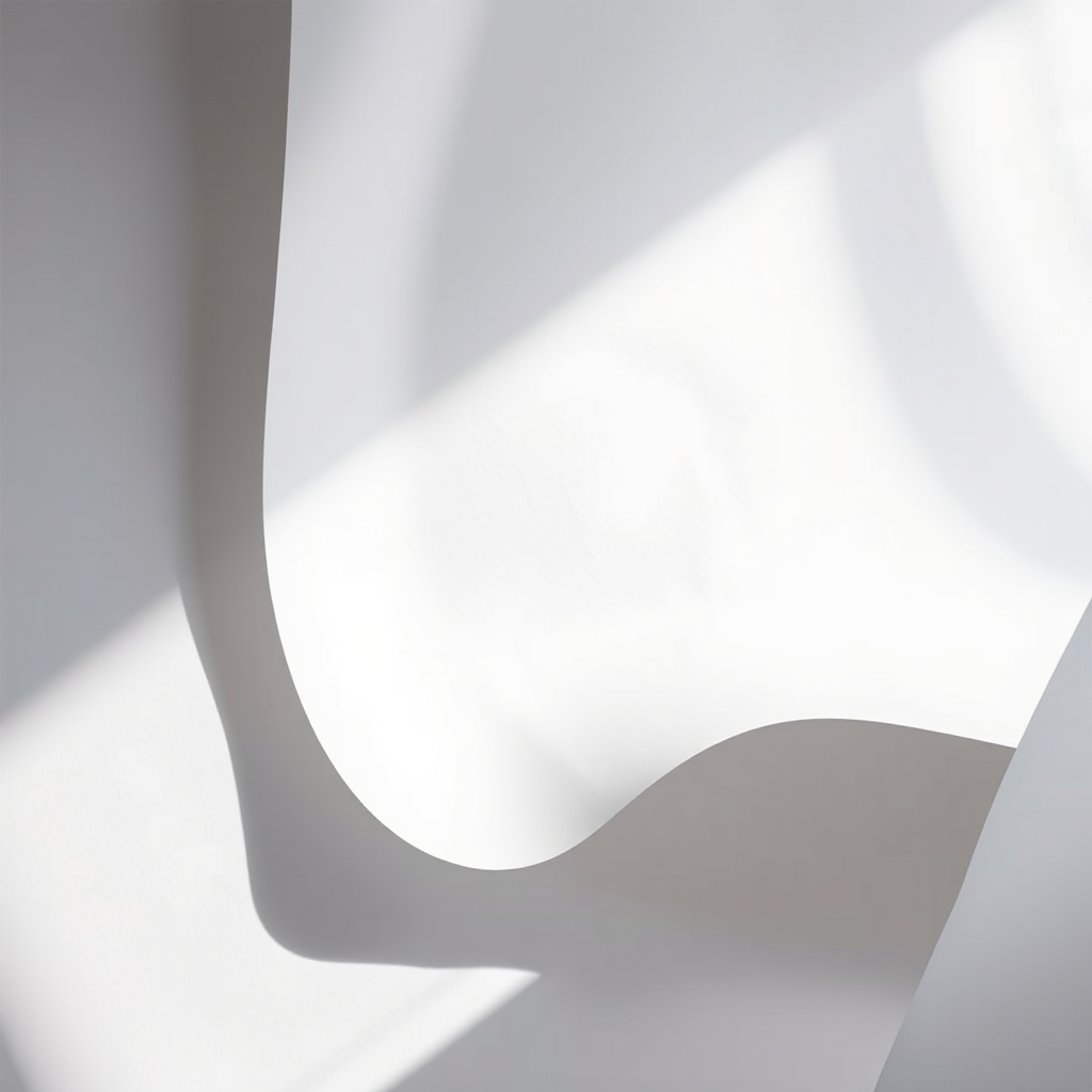 Create a high-resolution image of a large, curved sheet of white paper with soft shadows, using a DSLR camera with a 50mm lens, aperture set to f/2.8, ISO 100, and a slightly top-down angle to capture depth and details.
