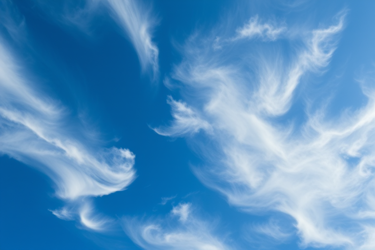 capture a high-resolution image of swirling white clouds against a deep blue sky using a DSLR camera with a 50mm lens, aperture f/8, ISO 100, shutter speed 1/200s, taken from a slightly upward angle to highlight cloud formations in vivid detail
