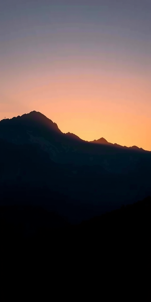 Create an image featuring a silhouette of a mountain landscape at sunrise, captured with a Canon EOS R5 camera, ISO 100, f/8 aperture, 1/125 shutter speed, shot from a wide-angle view with a landscape photography style.