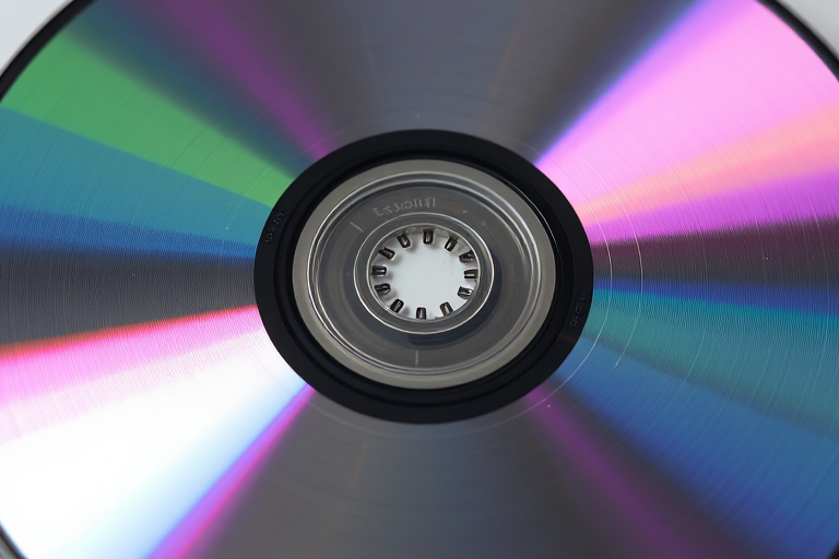 Create a high-resolution image of a scratched CD viewed from above with a reflective surface, using a DSLR camera with a 50mm lens, f-stop at 2.8, ISO 100, and a softbox light to enhance clarity and contrast.