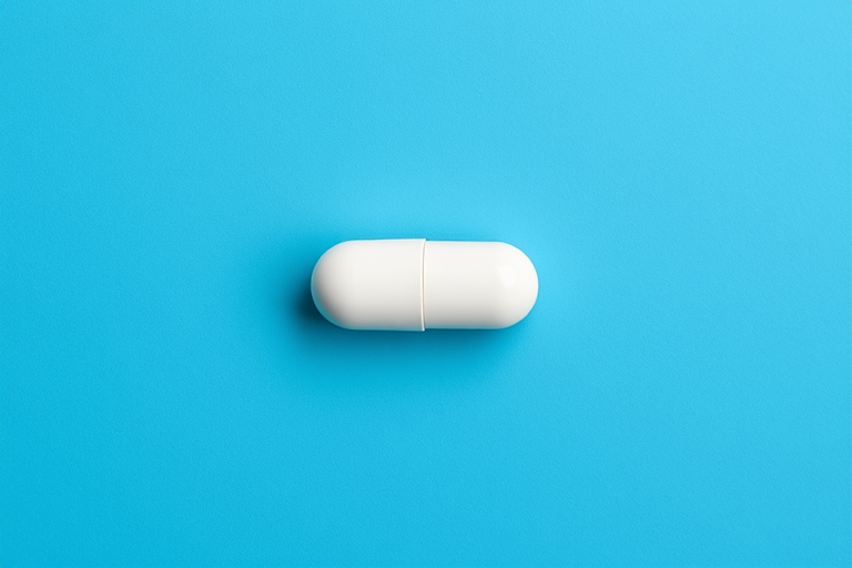 create an image of a white capsule on a solid blue background, shot with a 50mm lens at f/4, using a DSLR camera from a top-down perspective, high resolution, vibrant colors