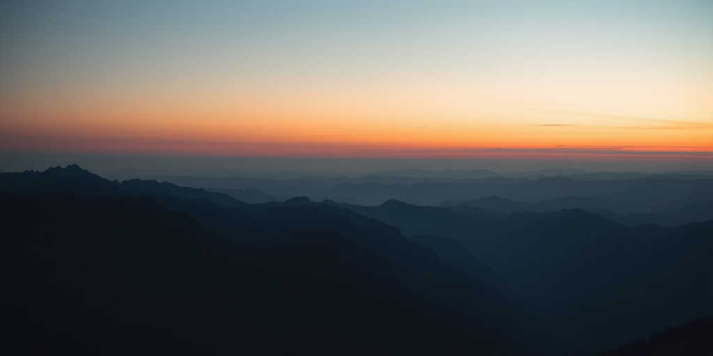 Capture a dramatic mountain landscape at twilight with a focal length of 24mm, aperture set to f/11, ISO 100, using a DSLR camera for sharpness and depth of field, with a wide-angle perspective to emphasize the valleys and layers of mountains in the background.