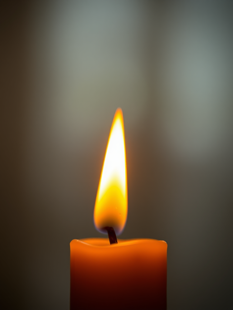 macro shot of a lit candle with a droplet of wax forming, soft bokeh background, f/2.8 aperture, ISO 200, 1/60 sec shutter speed, DSLR camera with 50mm lens, warm ambient lighting
