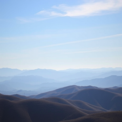 Generate a high-resolution image of a serene landscape featuring rolling hills and a clear blue sky, captured with a DSLR camera, 50mm lens at f/1.8, ISO 100, and a shutter speed of 1/200s, with a wide-angle view to enhance depth and clarity.
