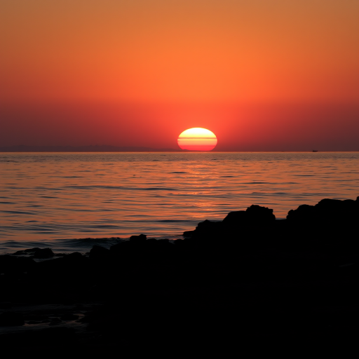 sunset over calm waters with a silhouetted rocky shoreline in the foreground, captured with a Canon EOS R5, 50mm lens, aperture f/1.8, ISO 100, shutter speed 1/200 sec, in landscape orientation for enhanced image quality