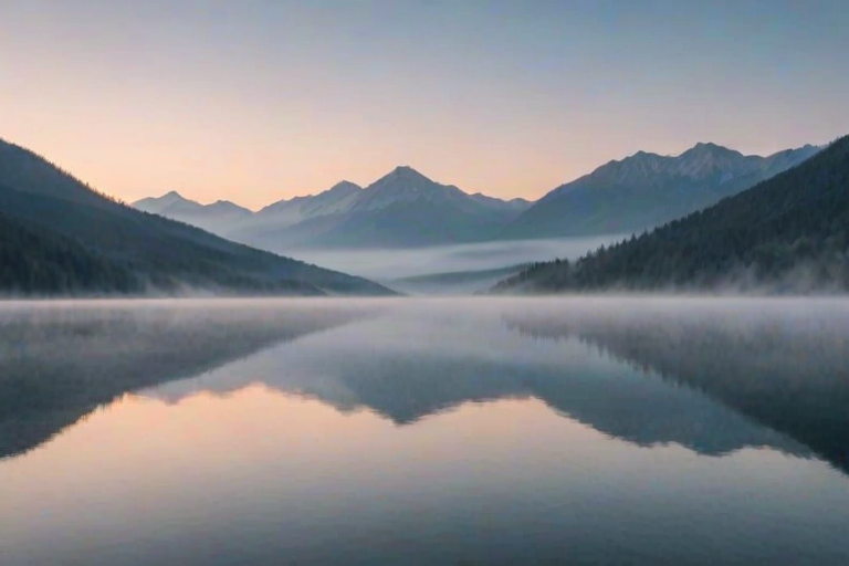 Soft-focus image of a serene mountain landscape at dawn, with mist rolling over the peaks, soft pastels in the sky, and a still lake perfectly mirroring the scene.