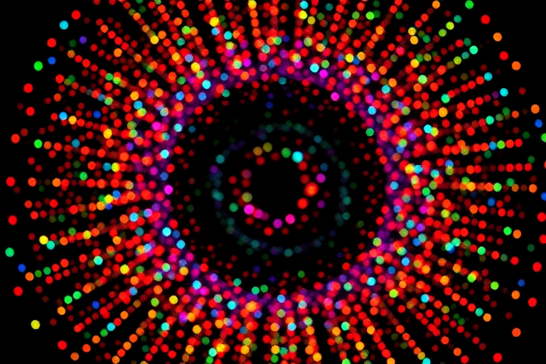 Generate a vibrant explosion of colorful dots in a circular formation on a black background, using a DSLR camera with a 50mm lens, aperture at f/2.8, shutter speed 1/200s, ISO 100, overhead view, and a shallow depth of field for enhanced image quality.