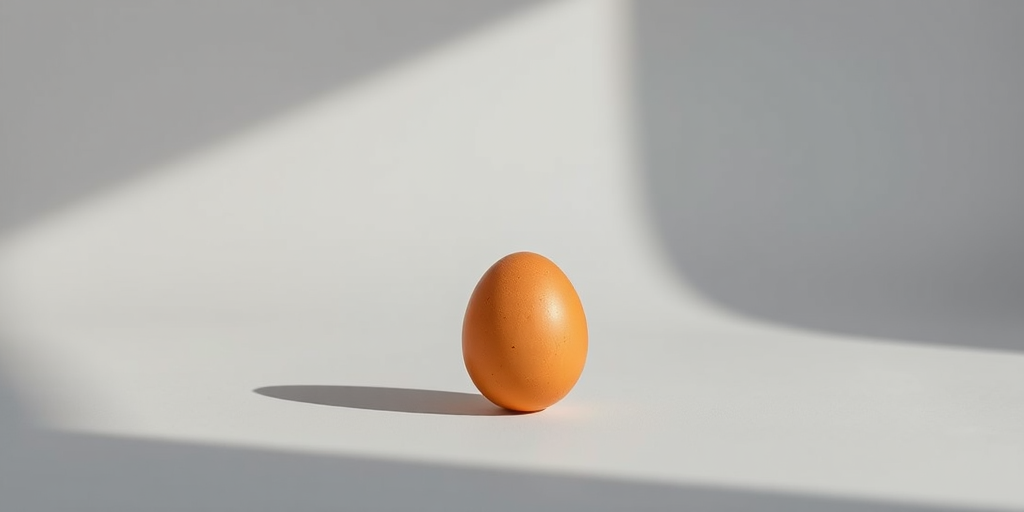 Create a high-resolution image of a single brown egg centered against a soft gray background, using a Canon EOS R5 camera, 50mm lens, aperture f/2.8, ISO 100, and natural lighting to enhance shadows and highlights.