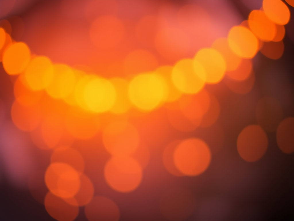 Create a warm, bokeh background with soft orange and purple tones, using a Canon EOS R5, 24mm lens, aperture f/2.8, shutter speed 1/60 sec, ISO 100, with a shallow depth of field for enhanced image quality.