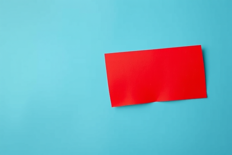 Create a vibrant red rectangular sticker with a slightly peeling edge on a smooth gradient blue background, captured with a DSLR camera at f/2.8, ISO 100, and a 50mm lens, ensuring sharp focus on the sticker and soft bokeh effect in the background.