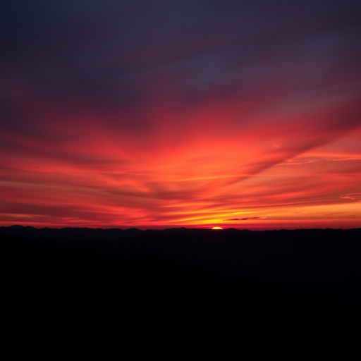 Capture a high-resolution image of a vibrant sunset over a silhouette of mountains, taken with a DSLR camera at f/8 aperture, ISO 100, and a 24mm focal length, using a landscape orientation and soft lighting to enhance colors and contrast.